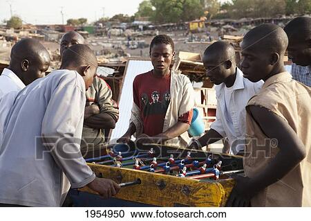 Young men playing table football in Mopti, Mali View Large Photo Image Stock Image - Young men playing table football in Mopti, Mali. Fotosearch