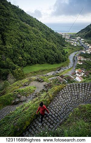 Stock Photograph - Young woman trekking in Faial da Terra; Sao Miguel, Azores, Portugal. Fotosearch