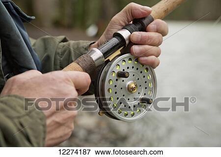 Stock Photo - A fisherman fishing in the Chilliwack River with a centerpin reel; Chilliwack, British Columbia, Canada. Fotosearch