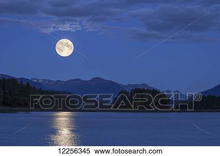 A full Moon rises over Auke Bay, Juneau, Southeast Alaska. View Large Photo Image Stock Photography - A full Moon rises over Auke Bay, Juneau, Southeast Alaska.. Fotosearch