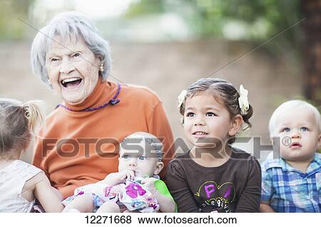 A great-grandmother enjoys some time with her great-grandchildren; Manhattan Beach, California, United States of America View Large Photo Image Stock Photo - A great-grandmother enjoys some time with her great-grandchildren; Manhattan Beach, California, United States of America. Fotosearch