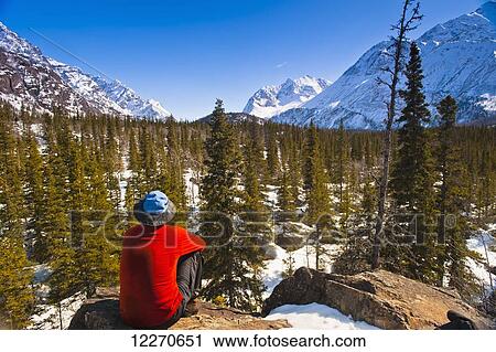A man sitting in the Eagle River Valley on a sunny winter day in South Central Alaska; Alaska, United States of America View Large Photo Image Stock Image - A man sitting in the Eagle River Valley on a sunny winter day in South Central Alaska; Alaska, United States of America. Fotosearch
