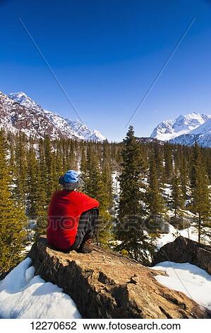 A man sitting in the Eagle River Valley on a sunny winter day in South Central Alaska; Alaska, United States of America View Large Photo Image Stock Image - A man sitting in the Eagle River Valley on a sunny winter day in South Central Alaska; Alaska, United States of America. Fotosearch