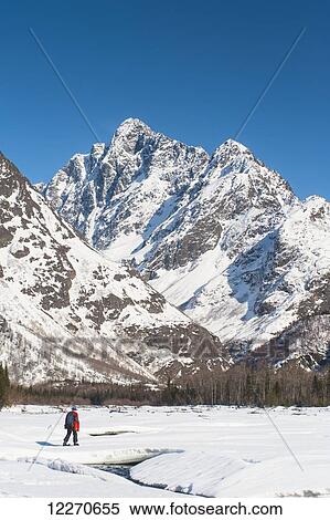 A man snowshoeing in the Eagle River Valley on a sunny winter day with Mount Yukla in the background, Chugach State Park; Alaska, United States of America View Large Photo Image Stock Photography - A man snowshoeing in the Eagle River Valley on a sunny winter day with Mount Yukla in the background, Chugach State Park; Alaska, United States of America. Fotosearch