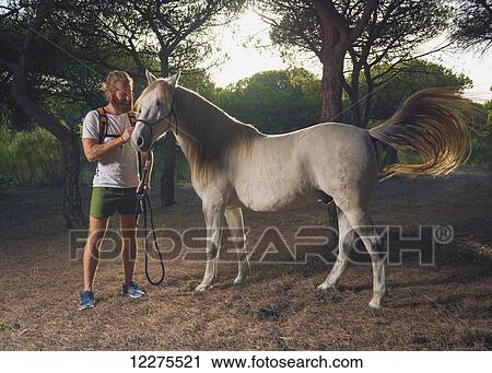 A man standing with a white horse; Cadiz, Andalusia, Spain View Large Photo Image Stock Image - A man standing with a white horse; Cadiz, Andalusia, Spain. Fotosearch