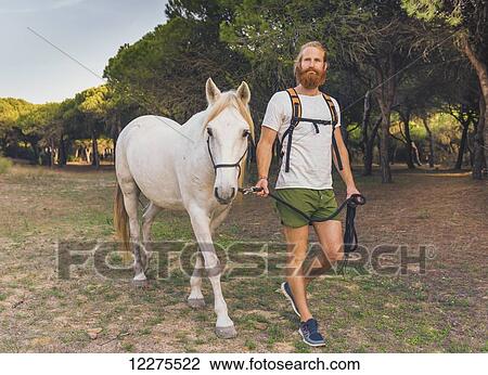 A man walking with a white horse; Cadiz, Andalusia, Spain View Large Photo Image Stock Image - A man walking with a white horse; Cadiz, Andalusia, Spain. Fotosearch