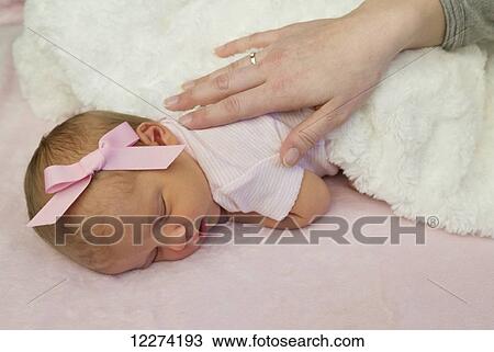 A mother's hand tenderly placed on her sleeping newborn baby girl; Chilliwack, British Columbia, Canada View Large Photo Image Stock Image - A mother's hand tenderly placed on her sleeping newborn baby girl; Chilliwack, British Columbia, Canada. Fotosearch