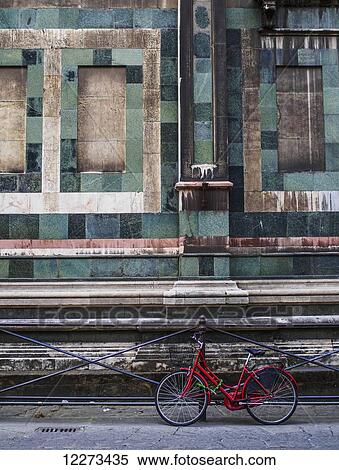 A red bike contrasted with the green granite of the building behind it; Florence, Italy View Large Photo Image Stock Photography - A red bike contrasted with the green granite of the building behind it; Florence, Italy. Fotosearch