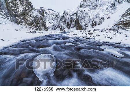 Stock Photo - A river flows out of the mountains in the area known as Thorsmork, Southern Iceland; Iceland. Fotosearch