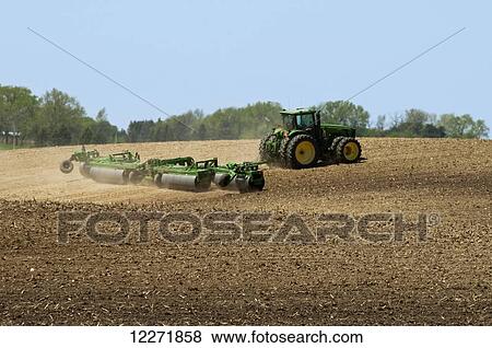 A tractor pulling a land roller over a recently tilled field prior to planting soybeans, near Truman; Minnesota, United States of America View Large Photo Image Stock Photo - A tractor pulling a land roller over a recently tilled field prior to planting soybeans, near Truman; Minnesota, United States of America. Fotosearch