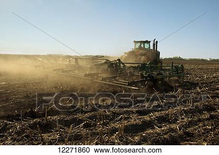 A tractor pulling a tillage implement prepares a field of corn stalks and residue for minimum tillage planting of soybeans, near Truman; Minnesota, United States of America View Large Photo Image Stock Image - A tractor pulling a tillage implement prepares a field of corn stalks and residue for minimum tillage planting of soybeans, near Truman; Minnesota, United States of America. Fotosearch