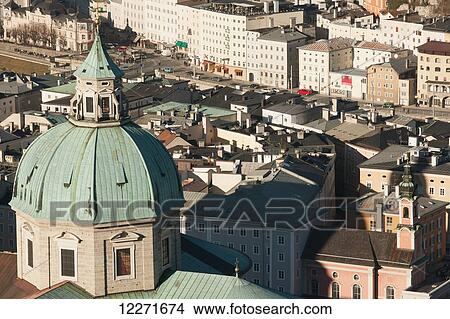 Picture - A view from the castle over the city's rooftops with the dome of the cathedral towering above the other buildings; Salzburg, Austria. Fotosearch