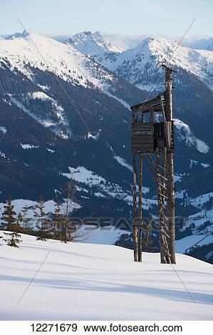 Stock Photo - A watch tower at the top of a ski piste with views across the mountain peaks of the Austrian Alps; Filzmoos, Austria. Fotosearch