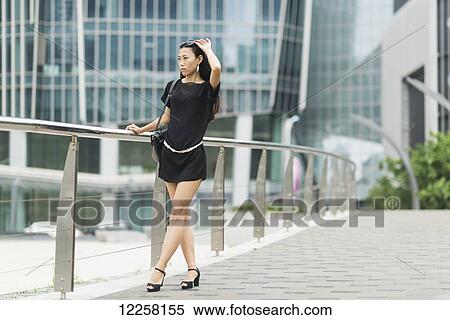 Stock Photography - A young woman in the business district; Xiamen, China. Fotosearch