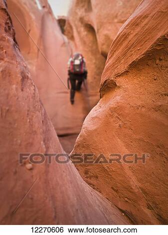 Adventurers exploring a desert slot canyon; Hanksville, Utah, United States of America View Large Photo Image Stock Photograph - Adventurers exploring a desert slot canyon; Hanksville, Utah, United States of America. Fotosearch