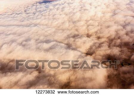 Stock Image - Aerial view of clouds obscuring the Kigluaik Mountains, North of Nome, Seward Peninsula; Alaska, United States of America. Fotosearch