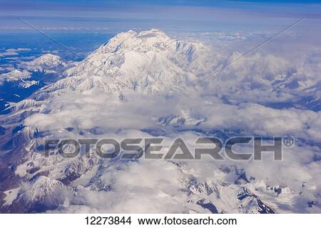 Picture - Aerial view of Mount McKinley from the West, lakes and glaciers, low altitude clouds in the distance, Denali National Park; Alaska, United States of America. Fotosearch