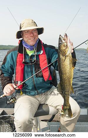 Angler holding a large summer walleye; Ontario, Canada View Large Photo Image Stock Photo - Angler holding a large summer walleye; Ontario, Canada. Fotosearch