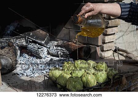 Artichokes with olive oil soon to be cooked; Tarragona, Benissanet, Spain View Large Photo Image Stock Image - Artichokes with olive oil soon to be cooked; Tarragona, Benissanet, Spain. Fotosearch