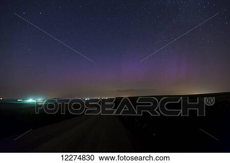 Stock Image - Aurora Borealis (Northern Lights) low on the horizon from Highway 3, near Colesburg; Iowa, United States of America. Fotosearch