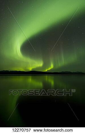 Stock Photo - Aurora Borealis (Northern Lights) reflected in 50 Mile Lake along the Denali Highway, Southcentral Alaska; Alaska, United States of America. Fotosearch