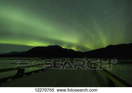 Stock Photography - Aurora Borealis (Northern Lights) dancing above the Susitna River bridge along the Denali Highway, Southcentral Alaska; Alaska, United States of America. Fotosearch
