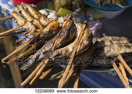 Stock Photo - Barbecued fish in Battambang market; Battambang, Cambodia. Fotosearch