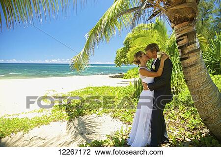 Stock Image - Beach wedding; Kauai, Hawaii, United States of America. Fotosearch