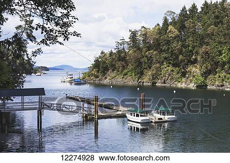Stock Photo - Boats in Butchart Cove; Victoria, British Columbia, Canada. Fotosearch