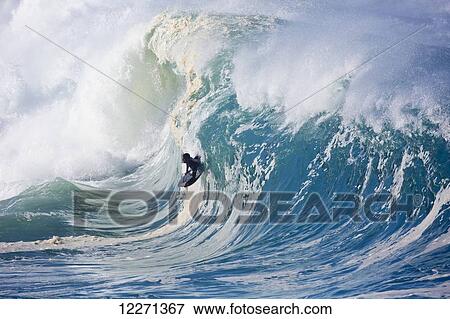 Stock Photo - Bodyboarder at Waimea Bay on the North shore of Oahu; Oahu, Hawaii, United States of America. Fotosearch