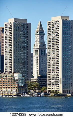 Boston skyline as seen from the bay, the Custom House Tower is between the two high rise buildings; Boston, Massachusetts, United States of America View Large Photo Image Stock Photo - Boston skyline as seen from the bay, the Custom House Tower is between the two high rise buildings; Boston, Massachusetts, United States of America. Fotosearch