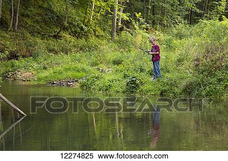 Stock Photography - Boy fishing in Bear Creek at Bixby State Preserve, near Edgewood; Iowa, United States of America. Fotosearch