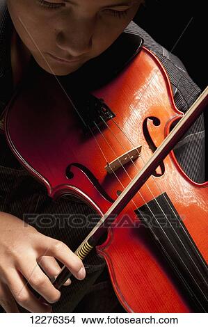 Boy playing violin; Edmonton, Alberta, Canada View Large Photo Image Picture - Boy playing violin; Edmonton, Alberta, Canada. Fotosearch
