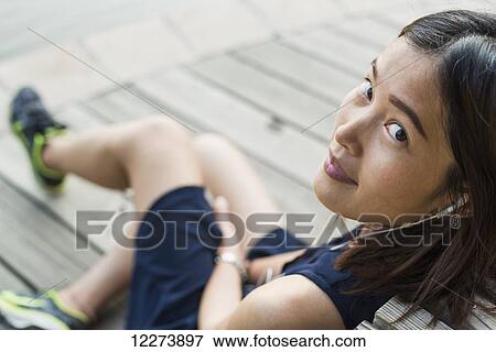 Chinese girl smiling and listening to music; Xiamen, Fujian province, China View Large Photo Image Stock Photo - Chinese girl smiling and listening to music; Xiamen, Fujian province, China. Fotosearch