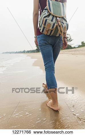 Chinese girl walking along Xiamen's beach; Xiamen, Fujian Province, China View Large Photo Image Stock Photograph - Chinese girl walking along Xiamen's beach; Xiamen, Fujian Province, China. Fotosearch