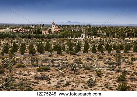 Stock Photography - Church steeple with cross and trees and plants on arid landscape; Phoenix, Arizona, United States of America. Fotosearch