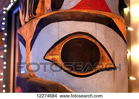 Picture - Close up of a totem pole with Christmas lights; Anchorage, Alaska, United States of America. Fotosearch