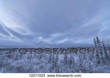 Stock Image - Clouds and mist envelop the mountains along the Annie Lake Road, near Whitehorse; Yukon, Canada. Fotosearch