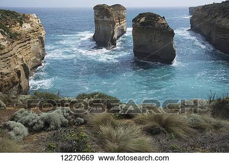 Stock Photo - Contrasting colours of sea and limestone on Australian coastline; Victoria, Australia. Fotosearch
