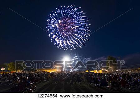 Crowd of people viewing the fourth of July fireworks; Earlville, Iowa, United States of America View Large Photo Image Picture - Crowd of people viewing the fourth of July fireworks; Earlville, Iowa, United States of America. Fotosearch