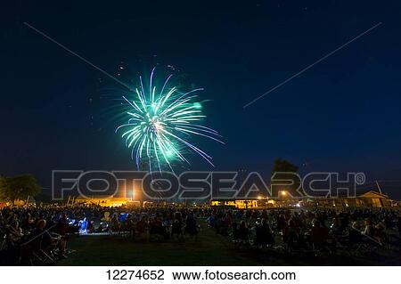 Crowd of people viewing the fourth of July fireworks; Earlville, Iowa, United States of America View Large Photo Image Stock Image - Crowd of people viewing the fourth of July fireworks; Earlville, Iowa, United States of America. Fotosearch