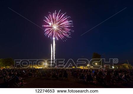 Stock Image - Crowd of people viewing the fourth of July fireworks; Earlville, Iowa, United States of America. Fotosearch