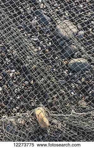 Stock Photography - Detail of fishing net stretched out along the rocky banks of the Noatak River; Noatak, Alaska, United States of America. Fotosearch