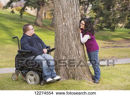 Disabled husband talking with his wife in a park in autumn; Edmonton, Alberta, Canada View Large Photo Image Picture - Disabled husband talking with his wife in a park in autumn; Edmonton, Alberta, Canada. Fotosearch