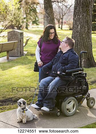 Disabled husband talking with his wife while walking in a park in autumn; Edmonton, Alberta, Canada View Large Photo Image Stock Image - Disabled husband talking with his wife while walking in a park in autumn; Edmonton, Alberta, Canada. Fotosearch