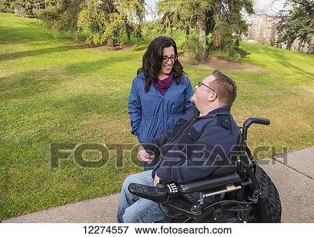 Disabled husband talking with his wife while walking in a park in autumn; Edmonton, Alberta, Canada View Large Photo Image Stock Photo - Disabled husband talking with his wife while walking in a park in autumn; Edmonton, Alberta, Canada. Fotosearch