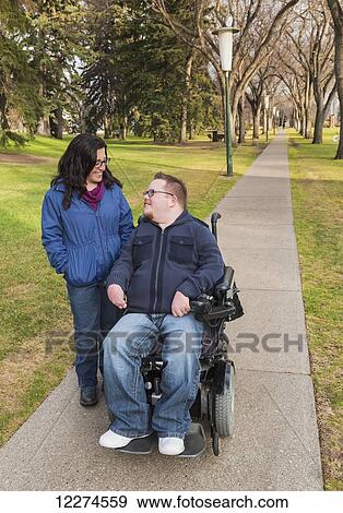 Disabled husband talking with his wife while walking in a park in autumn; Edmonton, Alberta, Canada View Large Photo Image Stock Photo - Disabled husband talking with his wife while walking in a park in autumn; Edmonton, Alberta, Canada. Fotosearch