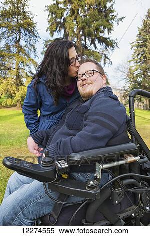 Stock Photography - Disabled husband with his wife in a park in autumn; Edmonton, Alberta, Canada. Fotosearch