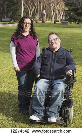 Disabled husband with his wife posing for a picture in a park in autumn; Edmonton, Alberta, Canada View Large Photo Image Stock Image - Disabled husband with his wife posing for a picture in a park in autumn; Edmonton, Alberta, Canada. Fotosearch