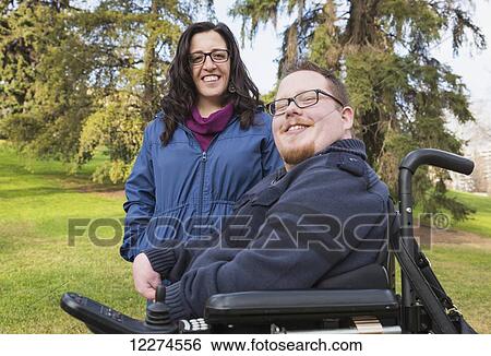 Disabled husband with his wife posing for a picture in a park in autumn; Edmonton, Alberta, Canada View Large Photo Image Stock Photograph - Disabled husband with his wife posing for a picture in a park in autumn; Edmonton, Alberta, Canada. Fotosearch